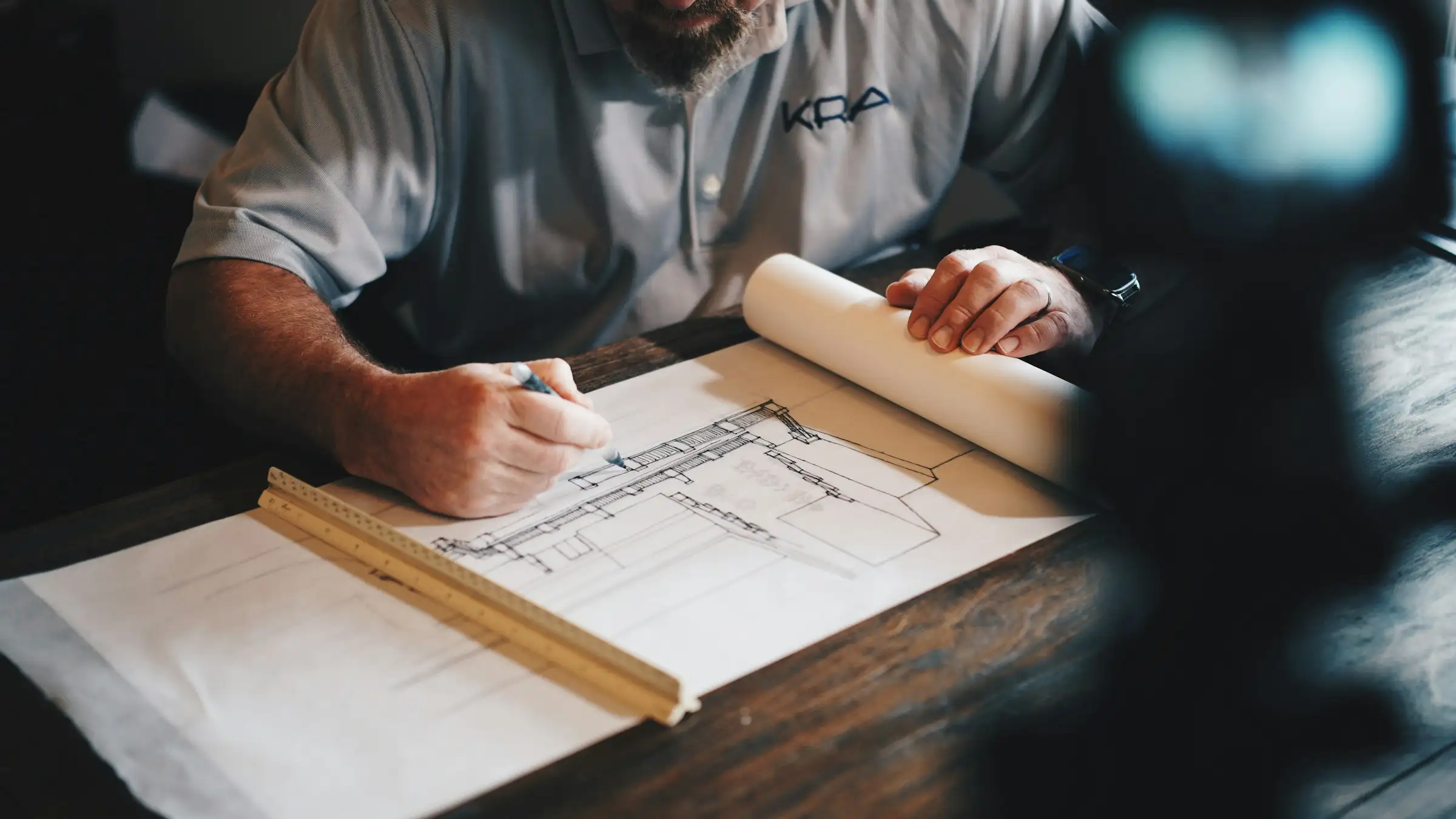 Reviewing architectural plans at a desk