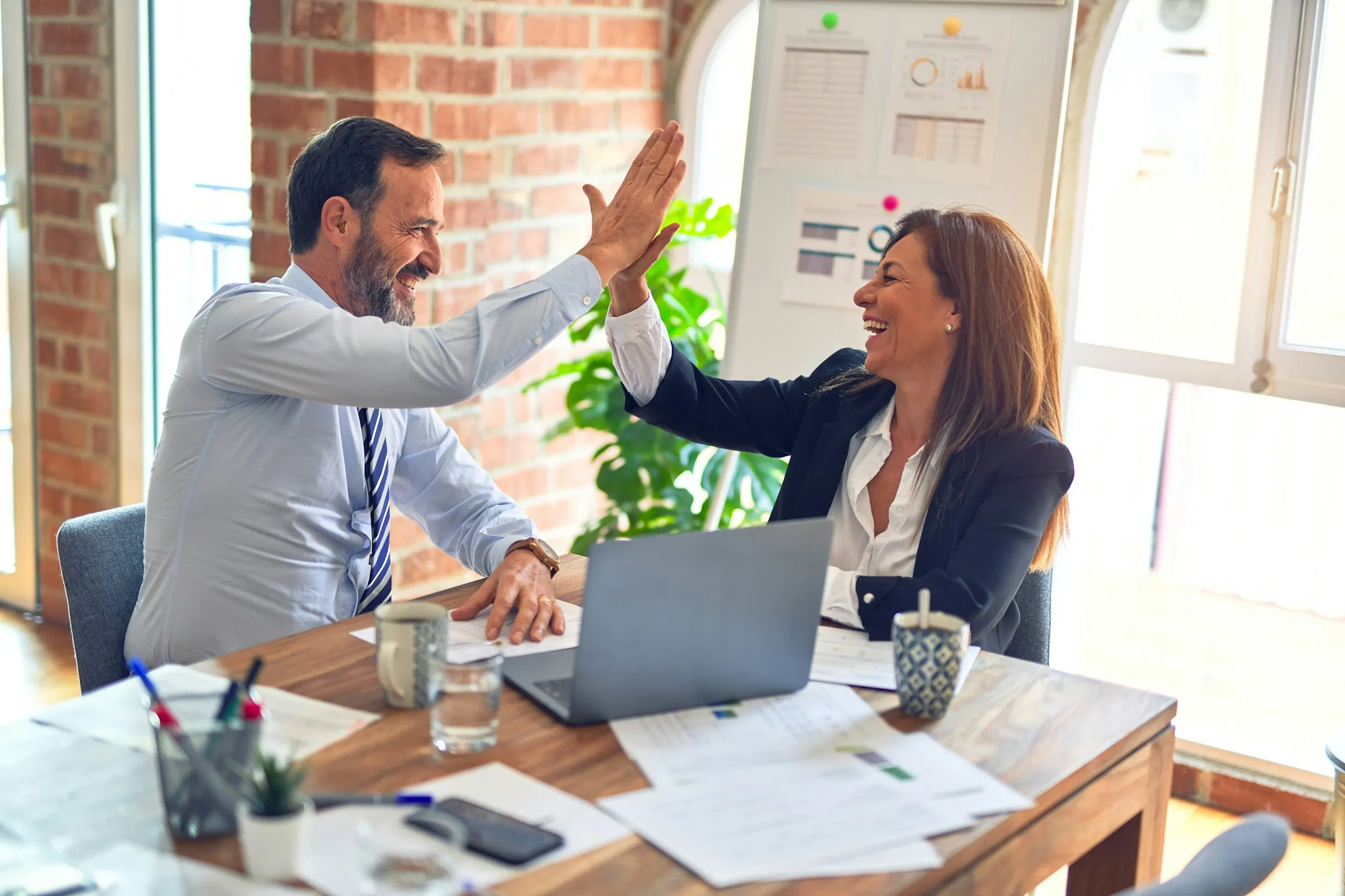 Real estate team celebrating with a high five